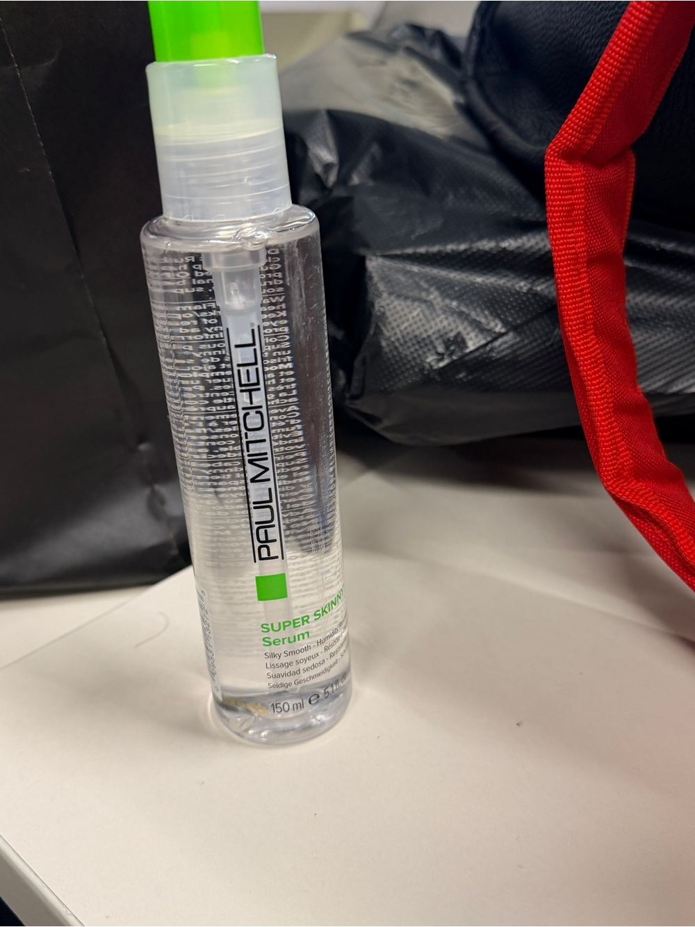 Paul Mitchell Serum Bottle with Bright Green Cap and Label Accent